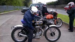 Barrie arrives on his lovely competion AJS.
