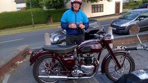 The maestro arrives on his fabulous 1956 Triumph Speed Twin.